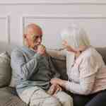 man in gray sweater sitting beside woman